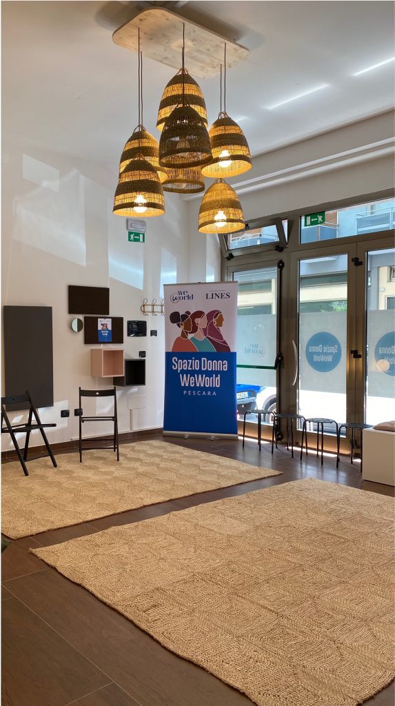 Interior of a room with a Lines and WeWorld banner indicating the Spazio Donna Pescara.